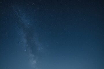 Obraz premium Vibrant blue night sky background with twinkling stars, perfect for adding celestial beauty to your projects