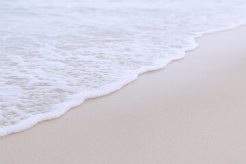 Gentle ocean wave receding onto sandy beach, creating a serene and peaceful coastal scenery background