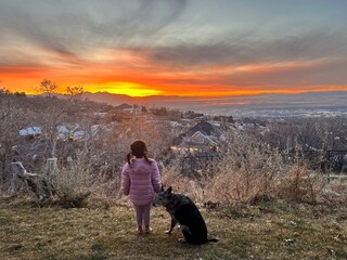 Child with dog at sunset 