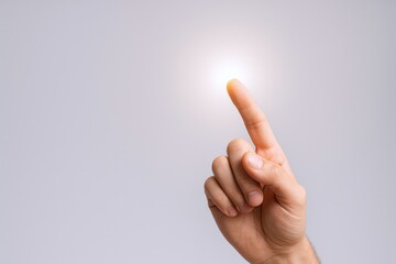 Human hand reaching towards a bright light source, concept for inspiration, ideas, innovation and creativity