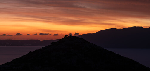 Vibrant Sunset Silhouette of Coastal Hills in Crete