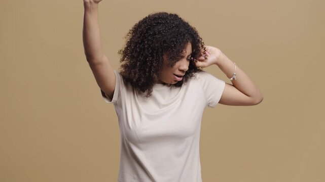 Tired Young Woman Yawning, Stretching on Beige Studio Background. Lazy teen girl didnt get enough sleep