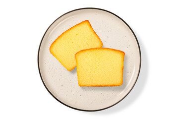 Two piece slices yellow cake on biege plate isolated on white background. Top view