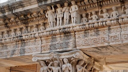 intricate stone pillar carvings of ancient figures and floral patterns | history, culture, travel, architecture, art theme