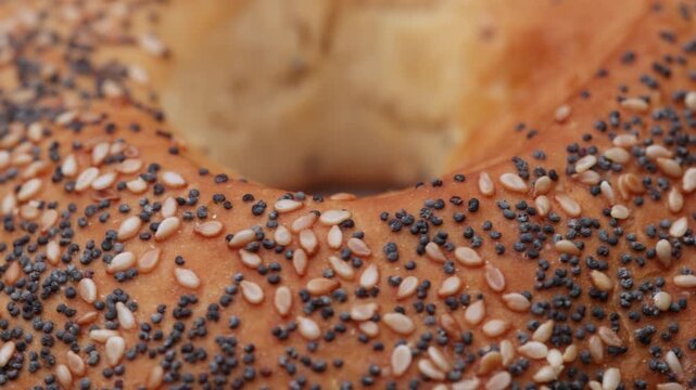 Macro rotation of seeded bagel bun shown as seamless loop for clean food design