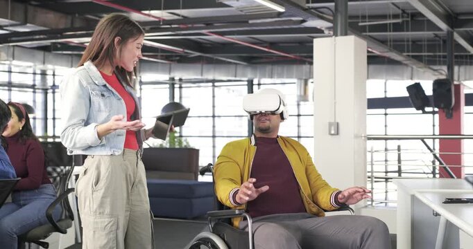 Diverse coworkers tapping tablet exploring VR with headset and switching phone in office