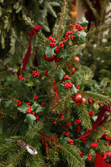 Christmas tree decorated with shiny red and gold ornaments, featuring lush green branches and sparkling lights, creating a joyful holiday ambiance
