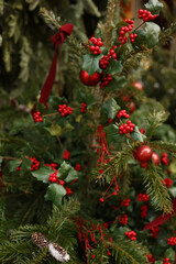 Christmas tree decorated with shiny red and gold ornaments, featuring lush green branches and sparkling lights, creating a joyful holiday ambiance