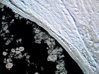 Bird's-eye view of ice floes drifting down a river © Martin