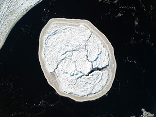 Bird's-eye view of an ice floe drifting on a river © Martin