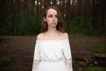 Serene Solitude: Woman in White Off-Shoulder Dress amidst Forest Tall Trees