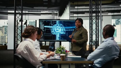 Investors meet in startup office to hear technology presentation from experienced computer scientist. African american woman and businessmen in tech agency boardroom participating in pitch, camera A - Powered by Adobe