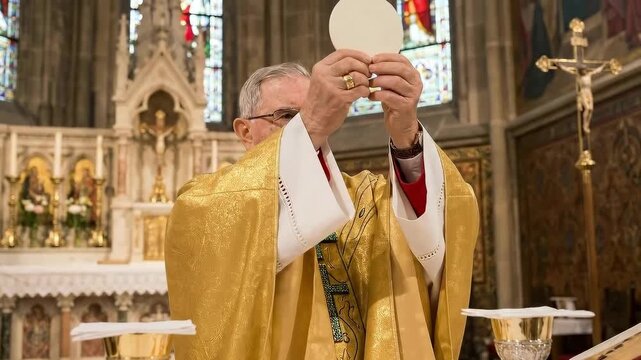 Bishop Elevating the Host During Consecration at Mass