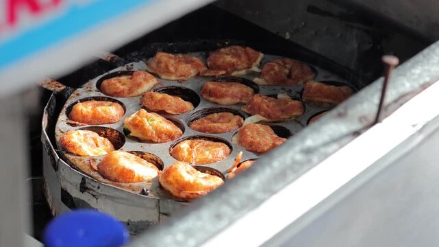 Cooking Traditional Indonesian Kue Cubit Street Food Snacks on a Hot Pan