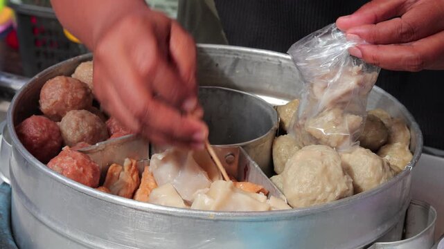 Variety of Indonesian Bakso Meatballs and Siomay Steamed in Traditional Metal Container