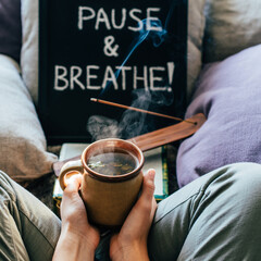 Cozy relaxation scene with tea incense and pause breathe sign for mindfulness and calm