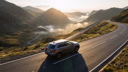Fototapeta premium Compact SUV on Elevated Ridge Road During Sunrise