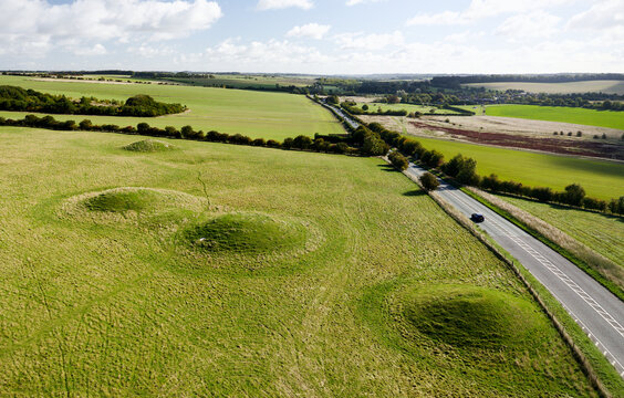 Four of the prehistoric round barrow burial mounds beside A4 road on Overton Hill, Avebury, at start point of the Ridgeway National Trail. View to E