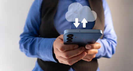 A businessman holds a cell phone with the cloud icon and an upward-pointing arrow, representing cloud computing seamlessly connecting to his mobile device.