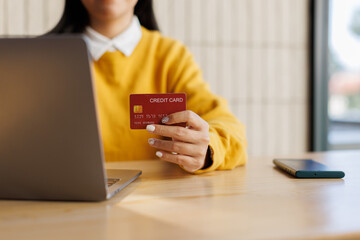 Customer verified online purchase with credit card and laptop at office desk. tax payment e...
