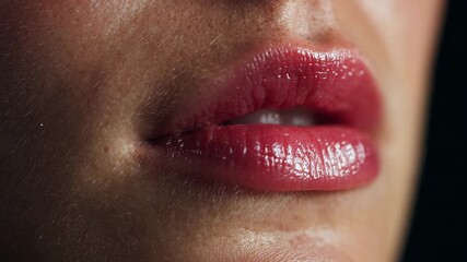 Red lipstick application close up