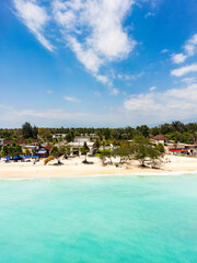 Beach resort in tropical island with white sandy beach in South East Asia, aerial topdown view by drone. Taken at Gili Islands, Lombok, Indonesia