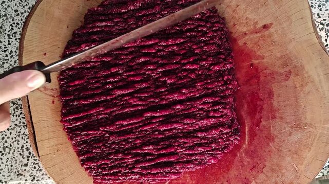 The focus is on selecting raw minced pork, slicing and preparing it on a wooden cutting board to make traditional Northern Thai-style larb.