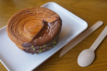 Croissant with chocolate and pistachio on a plate