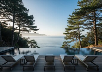 Fototapeta premium Luxury infinity pool with lounge chairs on a wooden deck overlooking a scenic ocean coast