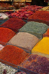 Fototapeta premium Colorful display of spices at market in afternoon light