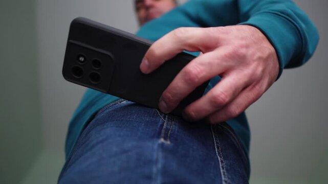 Person Checks on His Cell phone, Takes out His Smartphone from Jeans Pocket and the Back in