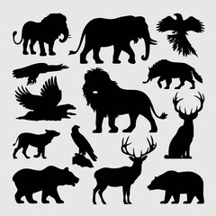 Obraz premium Collection of black silhouettes of various wild animals and birds including lions, elephants, bears, and deer