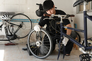 Authentic young tomboy repairing a flat bicycle tire in a garage. Independent female mechanic fixing a bike wheel with tools. DIY maintenance and empowerment concept.