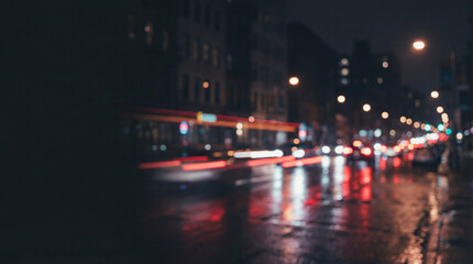 Night city street with traffic, blurred city car lights stretch along wet asphalt in soft focus, glowing bokeh reflections create moody city vibe for urban night life concept, contemporary mood