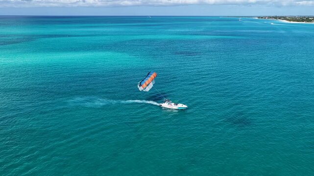 Parasailing At Providenciales In Turks And Caicos. Idyllic Beach. Nature Landscape. Aquatic Sport. Parasailing In Turks And Caicos. Aquatic Sport Landscape.