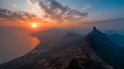 Aerial Sunset Over Coastal Mountains with Dramatic Clouds and Ocean Horizon