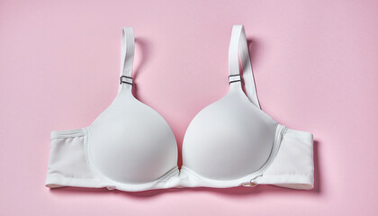 White Push-Up Bra with Adjustable Straps and Silver Rings Displayed on Pink Background