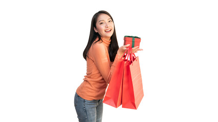 Happy Asian woman holding red shopping bags and gift box for Christmas and New Year holiday shopping.