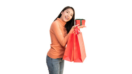 Happy Asian woman holding red shopping bags and gift box for Christmas and New Year holiday shopping.