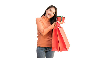 Happy Asian woman holding red shopping bags and gift box for Christmas and New Year holiday shopping.