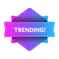 A vibrant neon sign displaying the word trending on a dark background