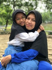 Mom and Daughter Holding Each Other in a Sweet Hug