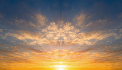 Vibrant orange and blue sky with dramatic clouds at sunrise or sunset.