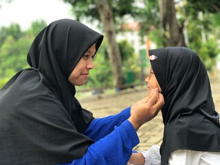 Mother and Daughter Connecting with a Soft Smile and Gentle Touch