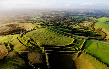 Eggardon Hill multivallate Iron Age hillfort, Dorset. Visible hut site depressions and Bronze Age linear earthworks and bowl barrow. Octagon is recent