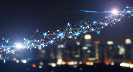 An abstract network of dotted lines stretches across a blurred cityscape at night, symbolizing digital connection and technology against an urban backdrop.
