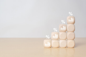 Interest rate finance and mortgage rates concept. Wooden blocks with growth of bar chart percentage...