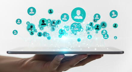 Hand holds tablet displaying teal user icons connected in a network against a white background, representing social media and digital communication.