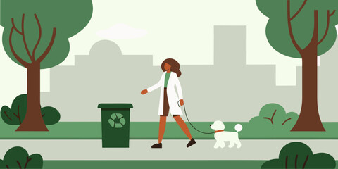 Woman walking a dog in a park with a recycling bin nearby