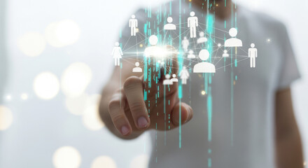 A man touches a holographic user interface projecting icons representing people, illuminated by light streaks on a blurred bokeh background showing technology and modern concepts.